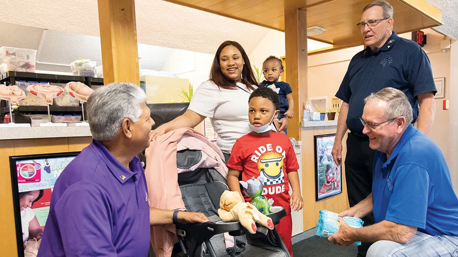 Illinois Knights speak with a mother and her children
