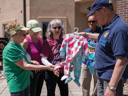 Grand Knight Randy Fritz of St. Peter Catholic Church Council 11514 in Monument, Colo., and other parishioners look through some of the baby clothes collected for Life Network pregnancy