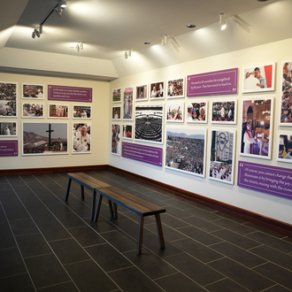 Color photo of a museum gallery with photographs on exhibit.