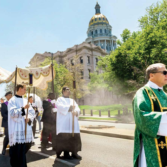 SERRA ROUTE | The Eucharist is carried past the Colorado State Capitol in Denver on June 9. Nearly 5,000 people took part in the procession. (Photo by Andy Sanchez/Denver Catholic)