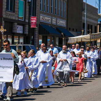 SERRA ROUTE | Parishioners of St. Patrick Catholic Church in Sidney, Neb., including members of Msgr. Anton Link Council 1861, process with the Eucharist through the center of town June 13. (Photo by Sean Lara).
