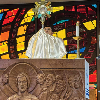 SETON ROUTE | Father Fernando Torres elevates the monstrance during Benediction at St. Pius X Church in Pittsburgh, June 13. (Photo courtesy of SetonPilgrimage.org).