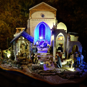 Nativity scene placed with a structure inspired by Gothic and Romanesque architecture. 