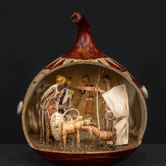 Crèche from Kenya housed in a hallowed out dried African gourd. The figures inside include the Holy Family, two goats, three wise men and a villager.