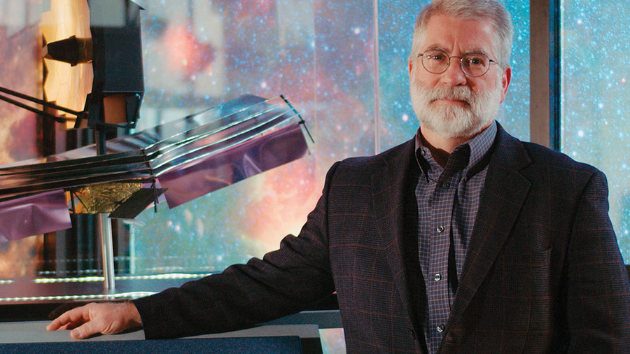 Michael Menzel, lead systems engineer of the James Webb Space Telescope, stands beside a model of the telescope at NASA’s Goddard Space Flight Center