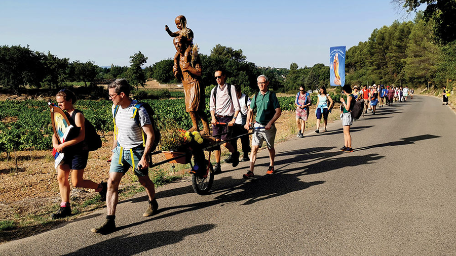 French Knights and other pilgrims wheel a statue of St. Joseph through the Burgundy countryside during the Great March of St. Joseph this past summer