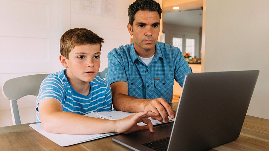 Father and son looking at a laptop