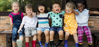 Card for Praesidium Academy with children sitting on a bench