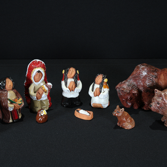 Painted clay Nativity with Holy Family and 3 Magi dressed in indigenous clothing along with a wolf, a bear, an owl, and a bison. 