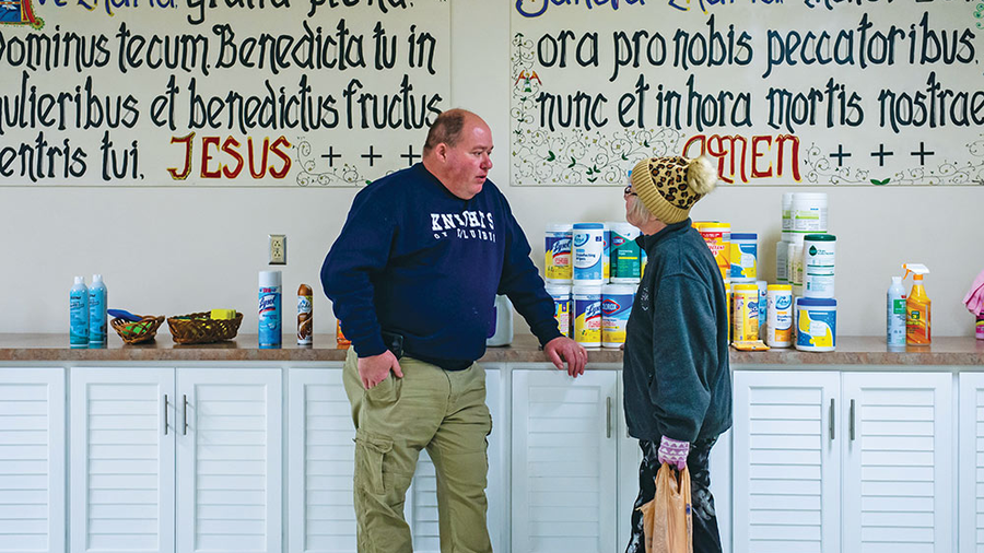 Rich Ferris, in East Palestine, assists a member of the community picking up cleaning supplies