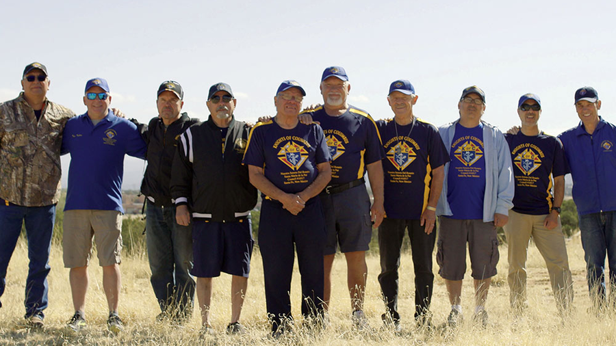 Knights who ran an evacuation site for people displaced by nearby wildfires stand together