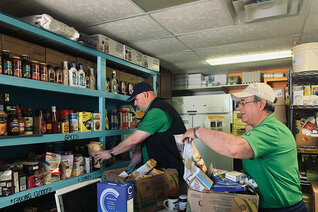 Saskatchewan State Deputy Chris Bencharski (right) and Grand Knight Kevin Rutt of Meadow Lake Council 5259 sort groceries at Door of Hope, a food pantry in Meadow Lake that serves many indigenous clients.