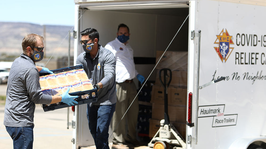 Jeremy Boucher, Lance Tanner and Supreme Director Patrick Mason — all members of Fray Marcos Council 1783 in Gallup — unload a trailer of supplies for the Acoma people in New Mexico.