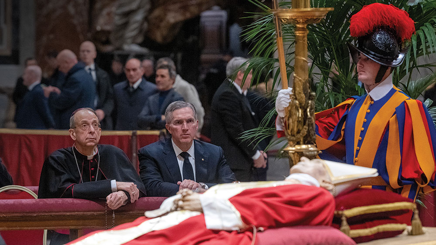 Supreme Chaplain Archbishop William Lori and Supreme Knight Patrick Kelly kneel in prayer before the body of Pope Benedict XVI in St. Peter’s Basilica on Jan. 3.