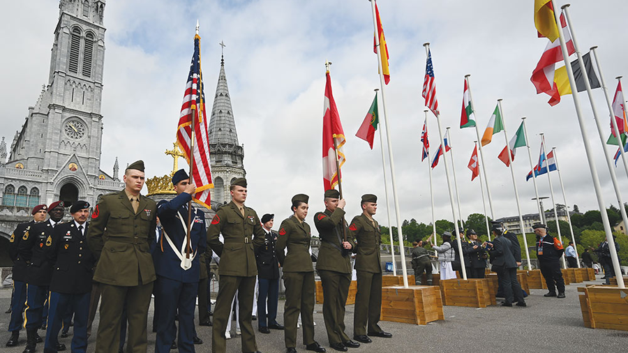 American service members participate in a military ceremony outside the Basilica of Our Lady of the Rosary