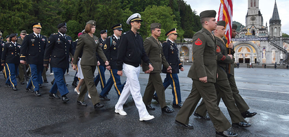 Warriors to Lourdes pilgrims march past the Sanctuary of Our Lady of Lourdes on their way to Mass at the Grotto on May 18, 2019.