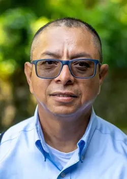 WTL Staff, Co-Trip Leader, Seattle/NW Team (JBLM), SSG Ervin Figueroa, USA/Ret. wearing a blue dress shirt and glasses.