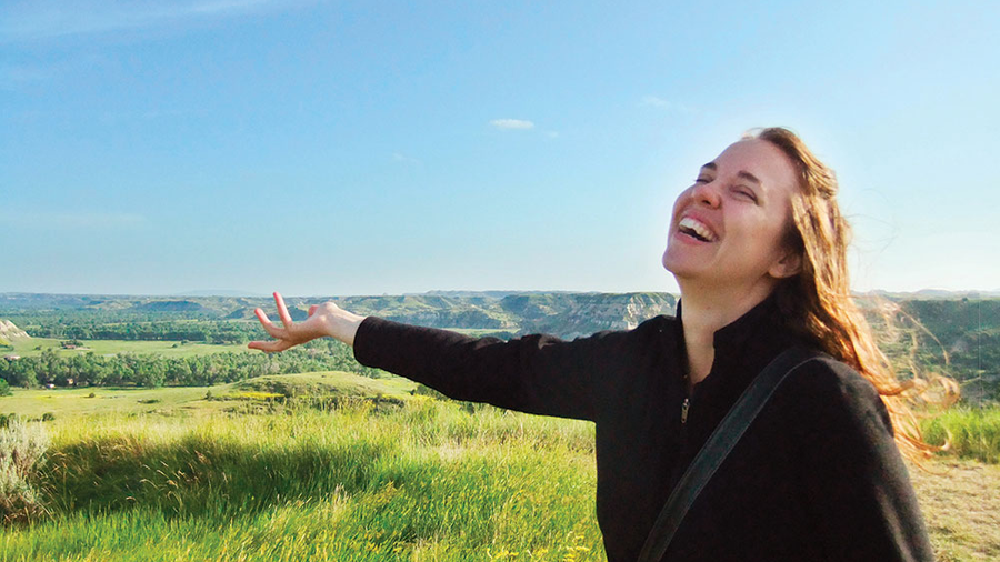 Michelle Duppong gestures joyfully to the beauty of the North Dakota Badlands during a visit to Theodore Roosevelt National Park around 2013. (Courtesy of the Duppong family)
