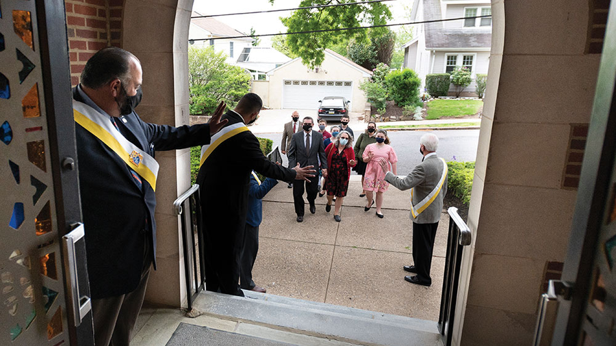 Grand Knight Joe Pargola (left) and other members of Father Joseph D. Gallagher Council 3673 welcome parishioners to Sunday Mass at Holy Trinity Catholic Church