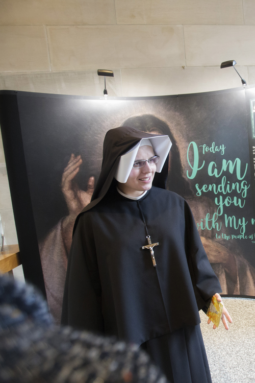 Sister Gaudia Skass speaks with pilgrims at JP2 Shrine
