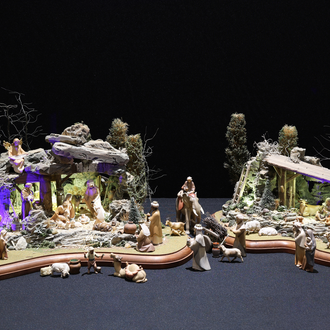 Photo of a Nativity scene made in honor of the first Nativity scene created by St. Francis of Assisi in Greccio, Italy, in 1223. It includes the saint and places the Holy Family in a grotto, or small cave.