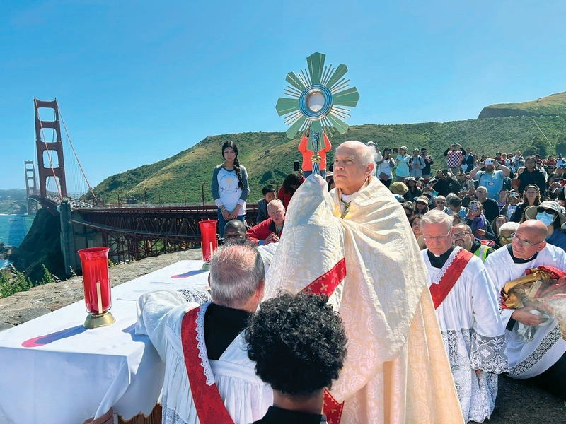 Archbishop Salvatore Cordileone of San Francisco raises the Blessed Sacrament after leading a pilgrimage walk across the Golden Gate Bridge on May 19, launching the Serra Route of the National Eucharistic Pilgrimage. (Photo by Roselle Reyes/EWTN News)
