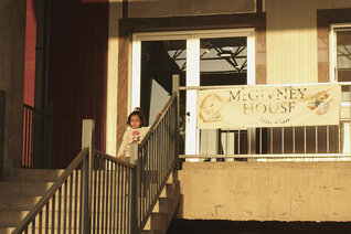 A child plays outside the entrance of McGivney House