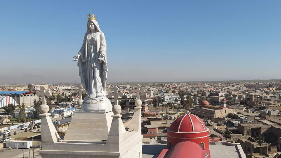 A 13-foot statue of Mary crowns the tower of the Church of the Immaculate Conception in Qaraqosh, Iraq