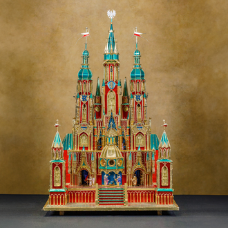 Photo of a paper Nativity with the Holy Family and other figures set within a castle. 