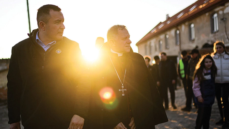 Ukraine State Deputy Youriy Maletskiy and Archbishop Mieczysław Mokrzycki visit Ukrainian families taking refuge at a monastery in Rava-Ruska in western Ukraine on April 12, 2022. (Photo by Andrey Gorb)