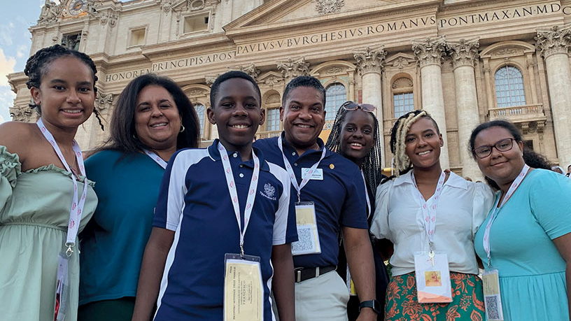 Damon and Melanie Owens stand with five of their eight children