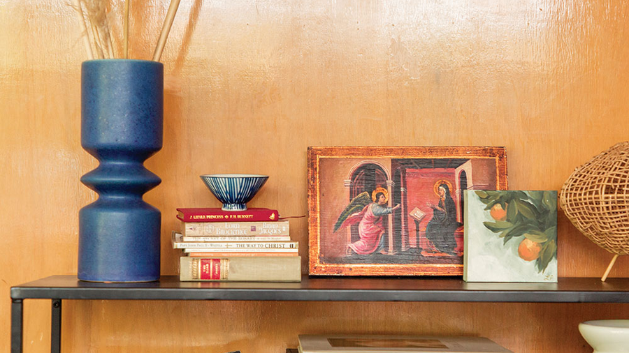 Shelves with books and a small painting