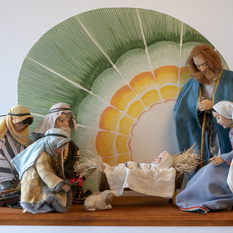 Nativity scene “Adoration of the Shepherds” by Nancy Schnarr-Bruell (figures) and John Bruell (backdrop) which includes the Holy Family and shepherds.