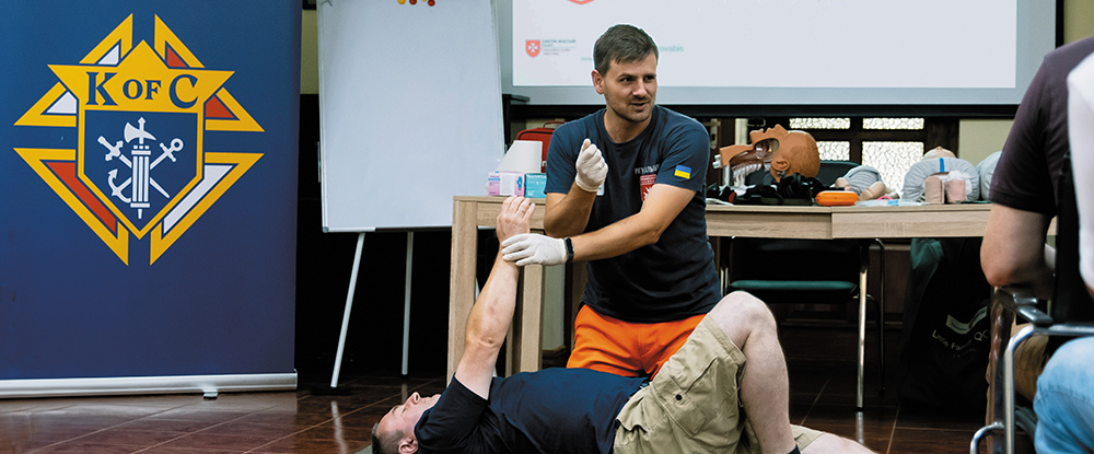 man giving demonstration on how to assist the a hurt individual.