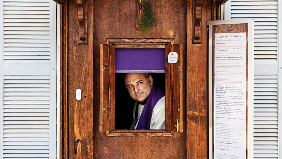 Father Seamus Griesbach sits at the confessional he built to fit in the window of the rectory of Our Lady of the Rosary Parish in Sabattus, Maine